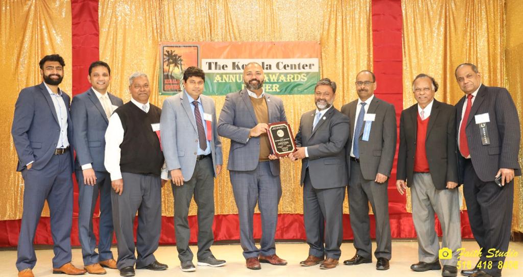 Missouri City Mayor Robin Elackatt Receiving award from NY State Senator Kevin Thomas. From l. to r.: James Thomas, Jimmy John, James Thottam, Dr. Madhu Bhaskaran, NY Senator Thomas, Mayor Elackatt, Alex Esthappan, John Paul and Dr. Thomas Abraham