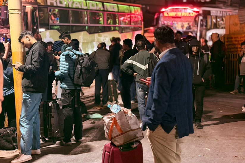 People wait for buses at Kalanki bus terminal, Nagarjun, on 27 February 2026, as thousands make their way back to their home constituencies ahead of the March 5 election. Photo by Rohit Dahal