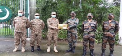 Indian and Pakistani Army officials exchange sweets