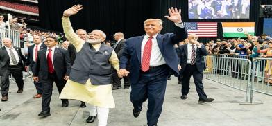 Prime Minister Narendra Modi and President Donald Trump stride around the Houston arena hand-in-hand on September 22, 2019, at the Howdy Modi event. (File Photo: White House)