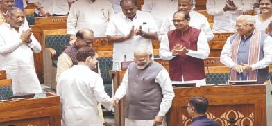 Prime Minister Narendra Modi and Leader of the Opposition Rahul Gandhi shaking hand in parliament Prime Minister Narendra Modi and Leader of the Opposition Rahul Gandhi shaking hand in parliament