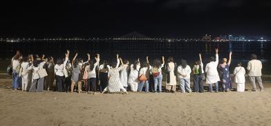 Mumbai peace walkers stand in solidarity at a beach in Central Mumbai. Mumbai peace walkers stand in solidarity at a beach in Central Mumbai.