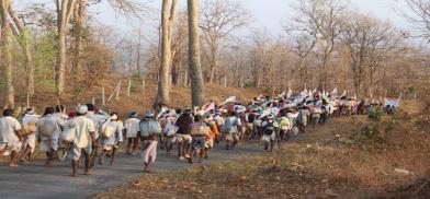 tribal people or local villagers in India facing home displacement or sitting near rural settlements