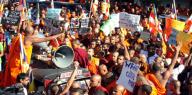 Sri Lankan Buddhist monks shout slogans and hold placards as they stage a protest rally outside the Bangladesh High Commission in Colombo