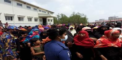 Rohingya refugees gather in an area of a complex housing at Bhashan Char in Bangladesh during a visit by senior officials of the United Nations refugee agency (UNHCR), May 31, 2021. (Source: BenarNews)