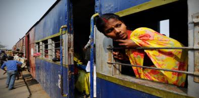 A woman on a train in Janakpur, Nepal. In its updated Nationally Determined Contribution, Nepal pledged to develop 200 kilometres of electric railway network by 2030. (Image: Leonid Plotkin / Alamy)