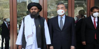 Chinese State Councilor and Foreign Minister Wang Yi (R) meets with Acting Deputy Prime Minister Mullah Abdul Ghani Baradar of the Afghan Taliban's interim government in Kabul